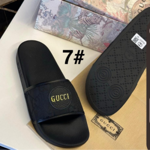 Gucci Black Slides with the Gucci Logo in Gold Letters